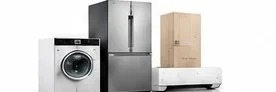 A washing machine, a refrigerator and an appliance still in its shipping carton, grouped together on a plain background.
